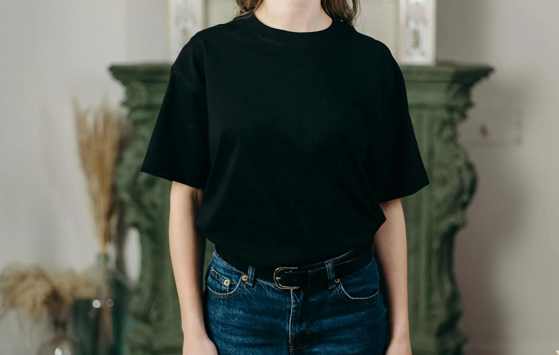 person in black crew neck t shirt and blue denim jeans