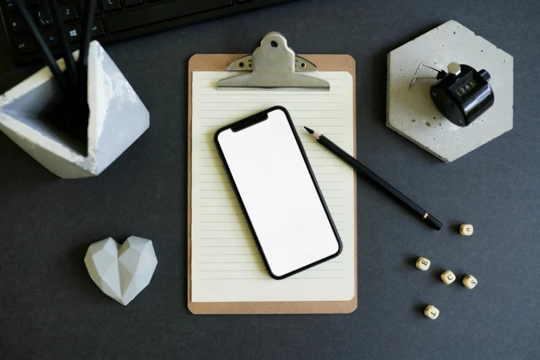 a smartphone over a paper on a clipboard